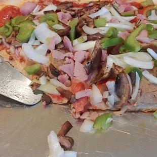 a half eaten pizza on a pan