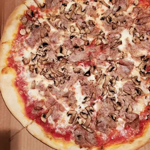 Sausage and mushroom regular pizza.