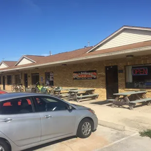 ows a car parked in front of a restaurant