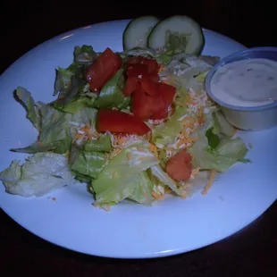 Dinner salad with a side of dressing.