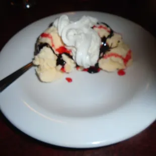 Vanilla ice cream with chocolate &amp; strawberry drizzle.