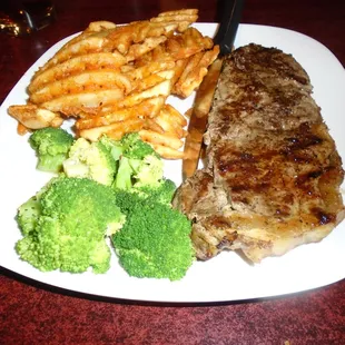 12 oz New York Strip dinner with waffle fries and broccoli.