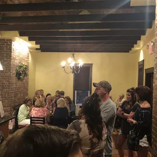 a large group of people in a tasting room