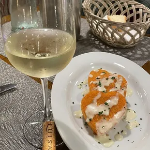 a plate of food and a glass of wine