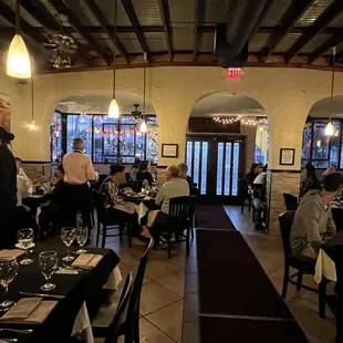 people sitting at tables in a restaurant