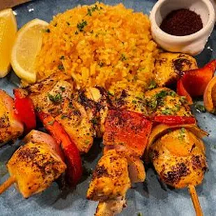 Lemon Saffron Chicken Kabobs with spanish rice  and sumac.. part of our healthy, fusion entree menu