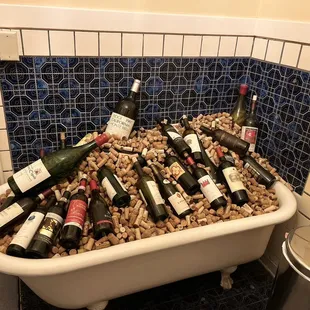 I had to take a pic of this tub filled with corks and bottles of wine in the bathroom
