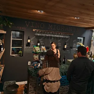 a group of people in a wine shop