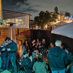 a group of people sitting outside at night