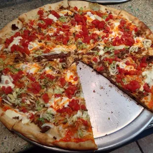 a pizza with a slice taken out of it