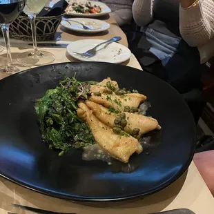 Petrale sole on a bed of sautéed spinach.