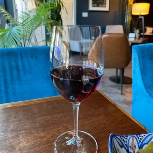 a glass of wine and a bowl of pickles