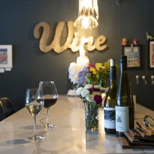 two glasses of wine and a bottle of wine