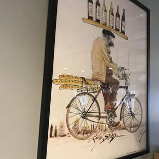 a man riding a bicycle with a basket of bread on the back