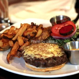 Piedmontese Hamburger with Cheddar ($22) - 8oz. Organic lettuce, tomato, red onion, pickle, dijon aioli, brioche bun. Hand-cut frites.