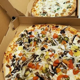 three pizzas in boxes