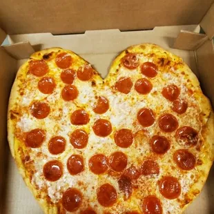a heart shaped pepperoni pizza