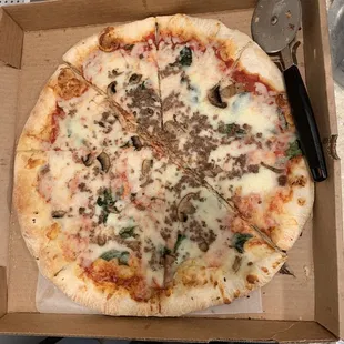 Pizza with lightly-baked crust and three toppings.