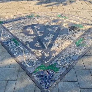 a mosaic floor in the middle of a patio
