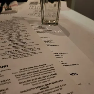 a glass of water and a menu