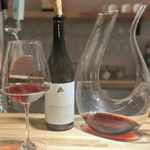 Decanter filled with wine, wine bottle and wine glass