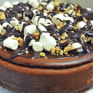 chocolate cheesecake, chocolate crust, layers of chocolate ganache, topped with mounds of walnuts, marshmallows and rich ganache