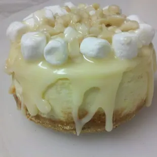 vanilla cheesecake, macadamia nut crust, smothered in white chocolate ganache, crowned with marshmallows and macadamia nuts.