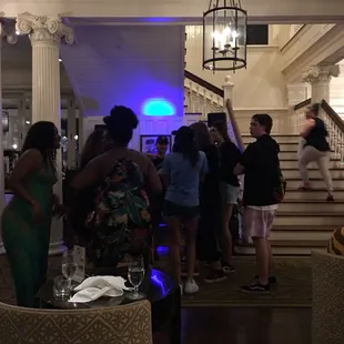 a group of people standing in a lobby