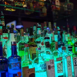 a row of liquor bottles on a bar counter