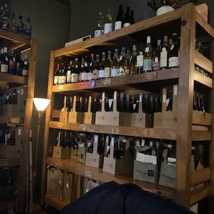 a shelf of bottles of wine