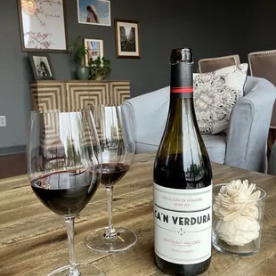 a bottle of wine and two glasses of wine