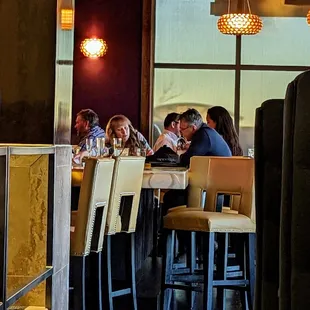a group of people sitting at a bar