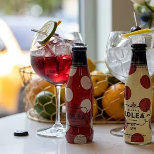 a bottle of oleea and a glass of red wine