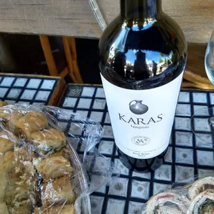 a bottle of wine and rolls