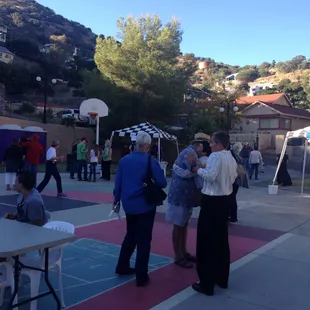 a group of people standing around a table