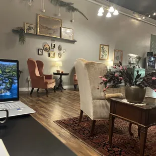 a coffee table, chairs, and a laptop