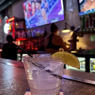 a cocktail with a lime slice in a glass