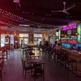 people sitting at the bar in a restaurant