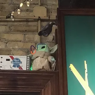 a shelf with a stuffed animal and christmas lights