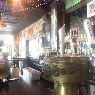 a bar with a brass table and bar stools