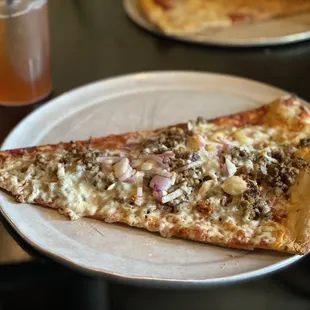 Pizza  with ground beef, bacon, and onions.