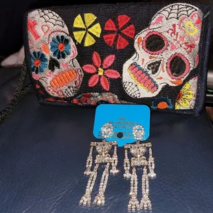 Phone, wallet and ID handsfree purse ( hangs from your neck) and rhinestone skellie earrings (Skellie moves!)