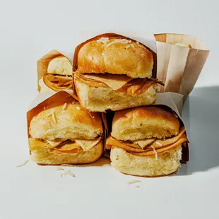 Sliders- made with fresh baked bread, homemade mozzarella and homemade vegan smoked turkey.