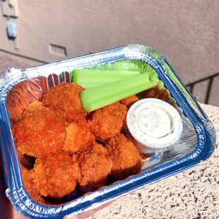a tray of buffalo wings and celery