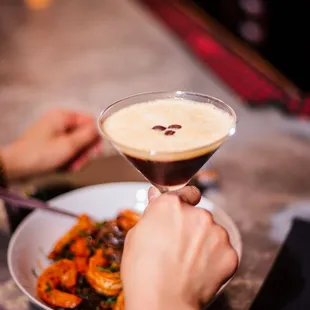 a person holding a martini glass