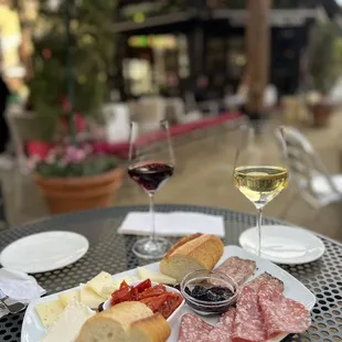 a plate of meat, cheese, and bread