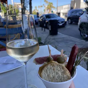 a glass of wine and a snack