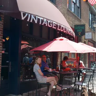 a woman sitting at a table outside