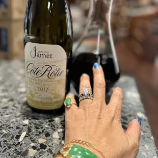 a woman's hand holding a glass of wine