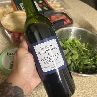 hand holding a bottle of wine